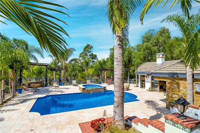 view of pool featuring an in ground hot tub, a patio area, and a pergola