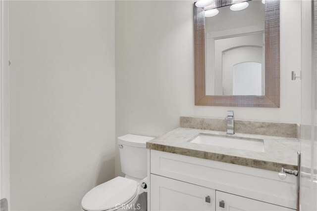 bathroom with toilet and vanity