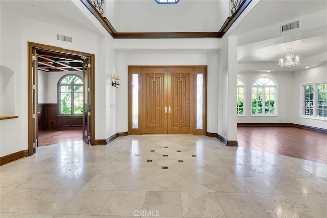 entrance foyer with a notable chandelier and a wealth of natural light