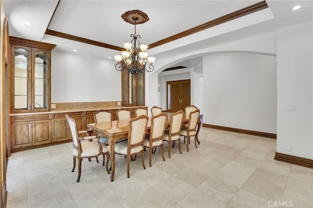 dining room featuring a chandelier, crown molding, and a tray ceiling