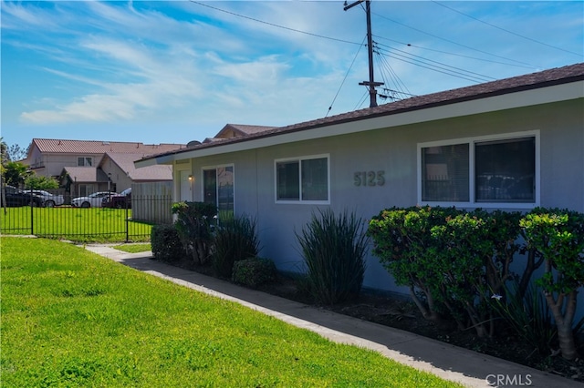 view of property exterior with a yard