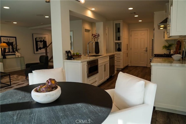 kitchen with recessed lighting, white cabinetry, a sink, and dishwashing machine