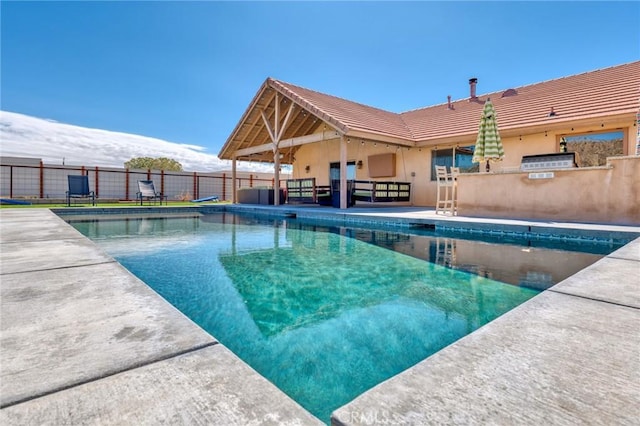 view of swimming pool featuring area for grilling and a patio