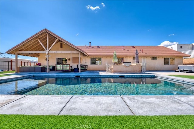 view of pool with a patio area and an outdoor kitchen