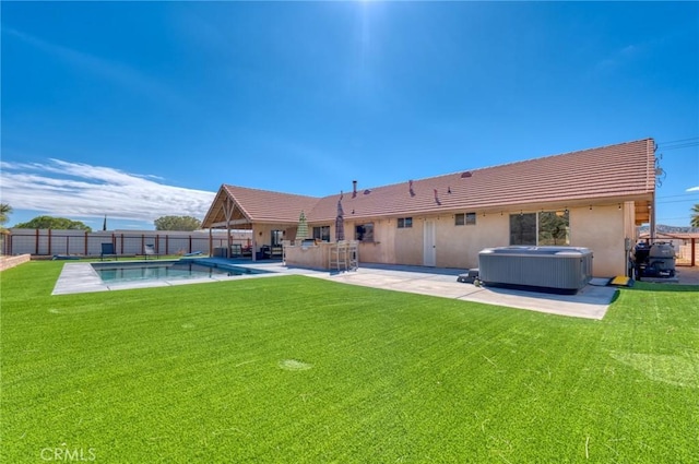 back of house with central AC unit, a pool with hot tub, a patio area, and a yard