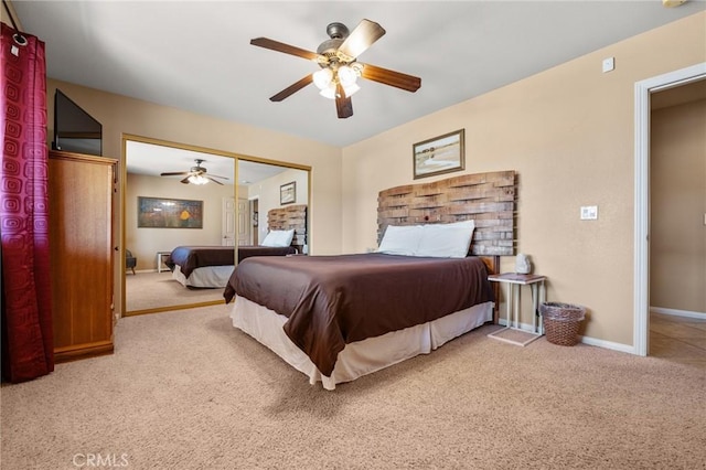 bedroom with ceiling fan, a closet, and light carpet