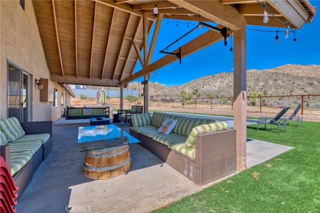 view of patio featuring an outdoor living space and a mountain view