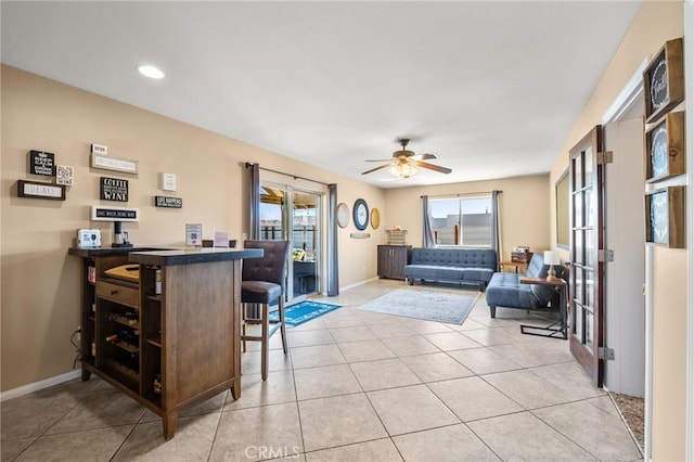 tiled living room with ceiling fan