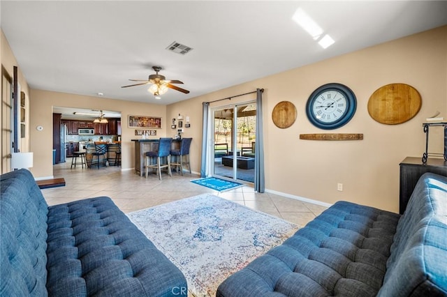 tiled living room featuring ceiling fan