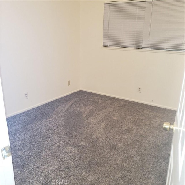 empty room with dark carpet