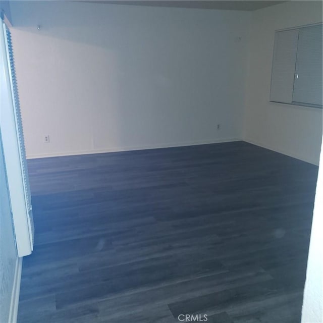 empty room with dark hardwood / wood-style floors