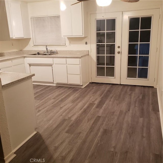 kitchen featuring white cabinetry, dark hardwood / wood-style flooring, and sink