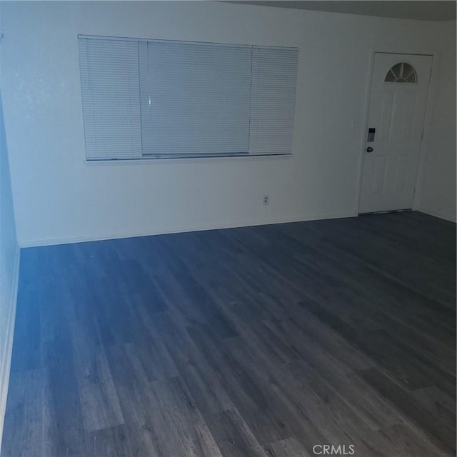 unfurnished room with dark hardwood / wood-style floors