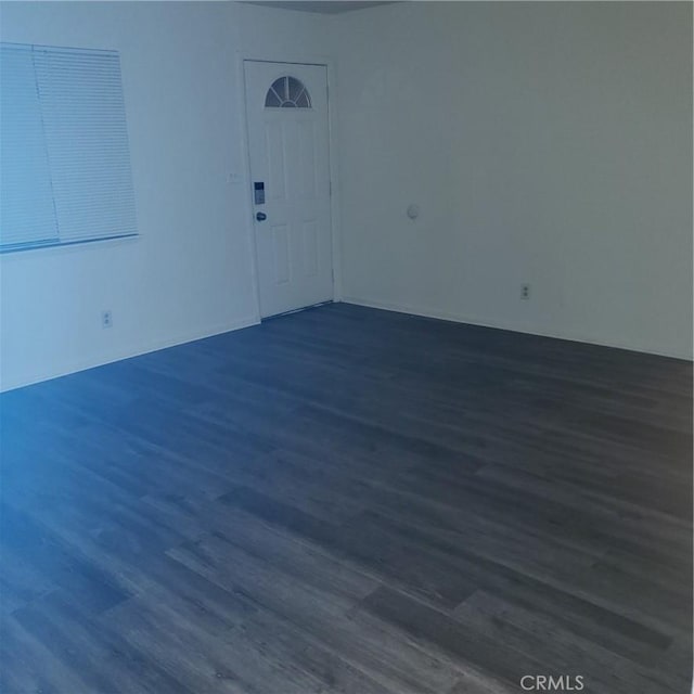 unfurnished room featuring dark hardwood / wood-style floors