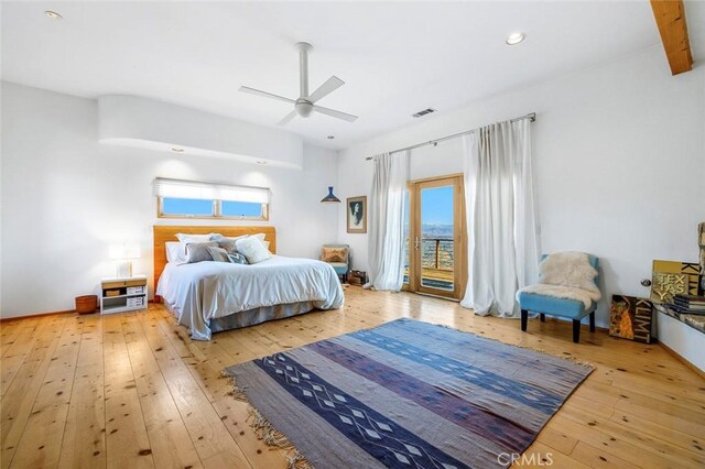 bedroom featuring beam ceiling, access to outside, light hardwood / wood-style floors, and ceiling fan