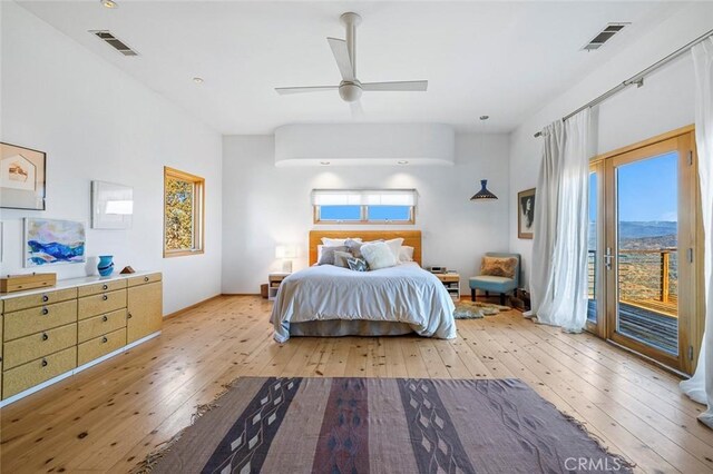 bedroom with light hardwood / wood-style floors, access to outside, and ceiling fan