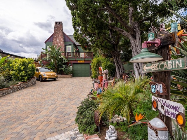 exterior space with a garage and decorative driveway