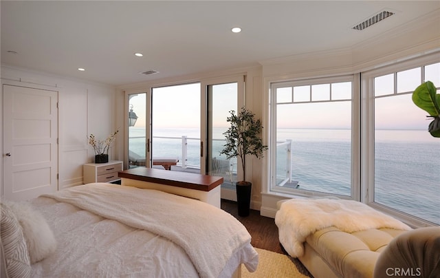 bedroom featuring crown molding, a water view, access to outside, and dark wood-type flooring