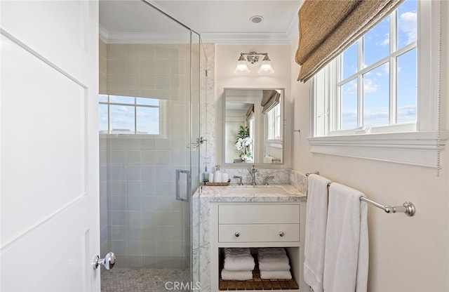 bathroom with walk in shower, vanity, and crown molding