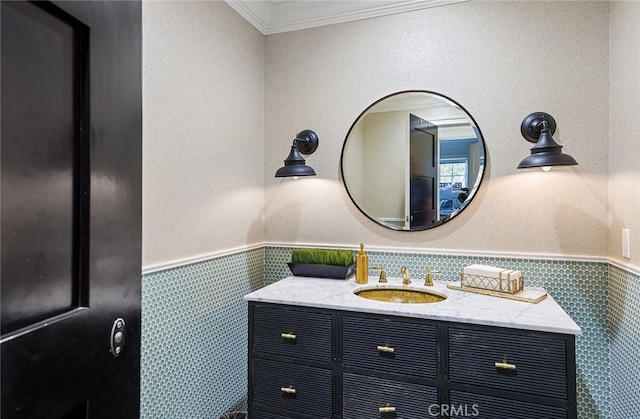 bathroom featuring ornamental molding, vanity, and tile walls