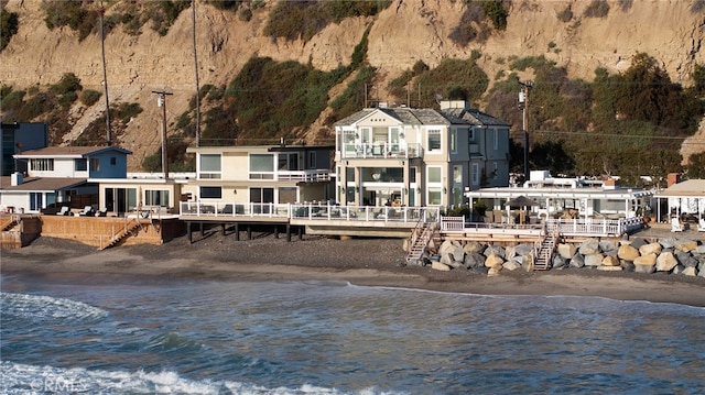 exterior space featuring a balcony and a water view