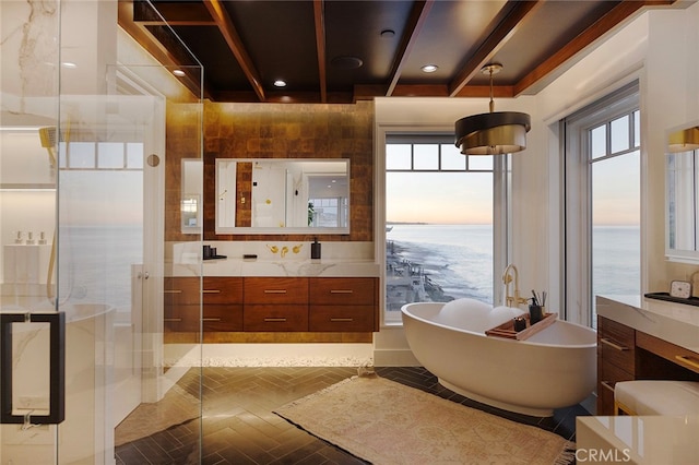 bathroom featuring a water view, vanity, separate shower and tub, and beamed ceiling