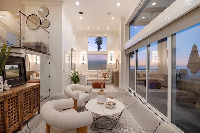 living room with ornamental molding and a healthy amount of sunlight