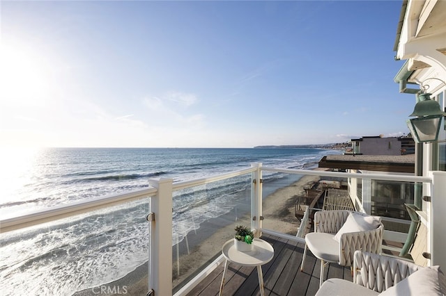 balcony with a view of the beach and a water view