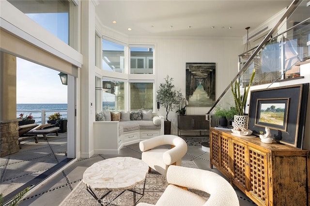 living room featuring a healthy amount of sunlight and a water view