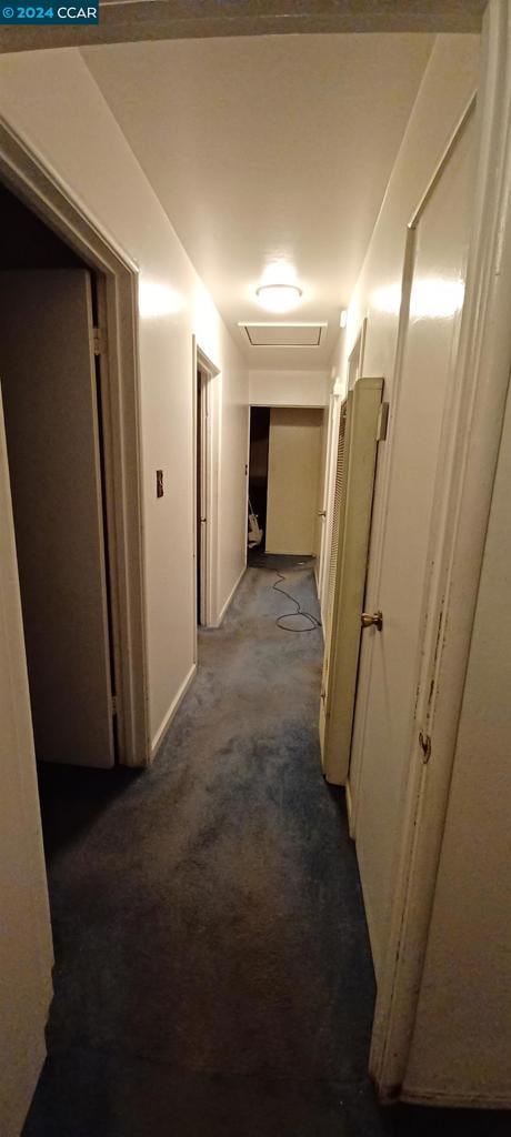 hallway featuring light colored carpet