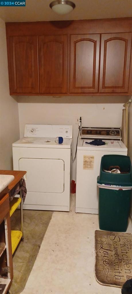 laundry room featuring cabinets and washing machine and dryer