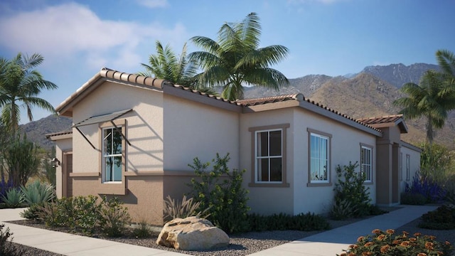 view of side of home with a mountain view