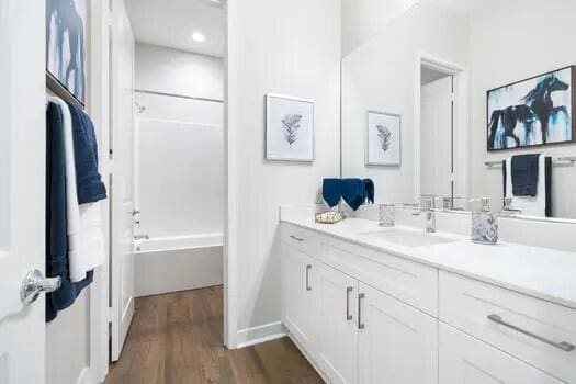 bathroom featuring vanity, shower / washtub combination, and wood-type flooring