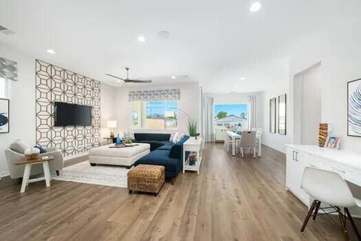 living room featuring ceiling fan and hardwood / wood-style floors