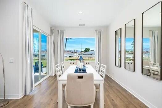 dining area featuring hardwood / wood-style flooring and plenty of natural light