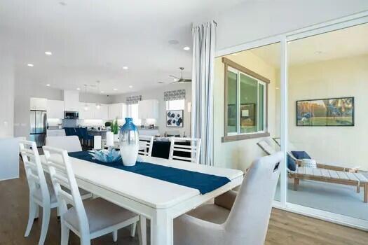 dining space featuring hardwood / wood-style floors and ceiling fan