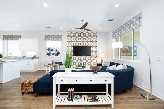 living room with sink, hardwood / wood-style floors, and ceiling fan