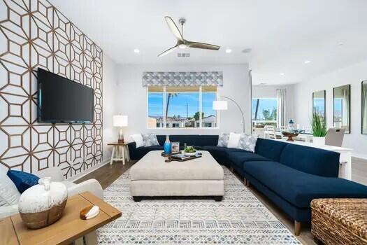 living room featuring ceiling fan and wood-type flooring