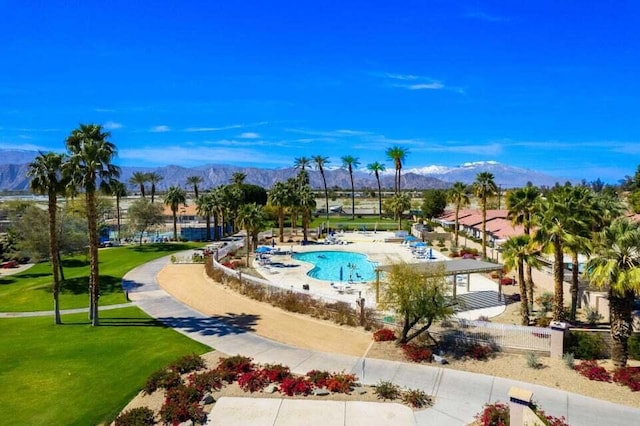 view of pool with a yard and a mountain view