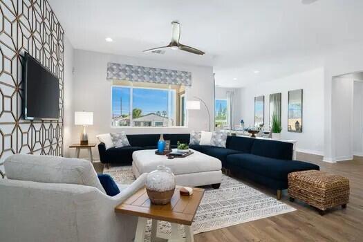 living room with hardwood / wood-style flooring and ceiling fan