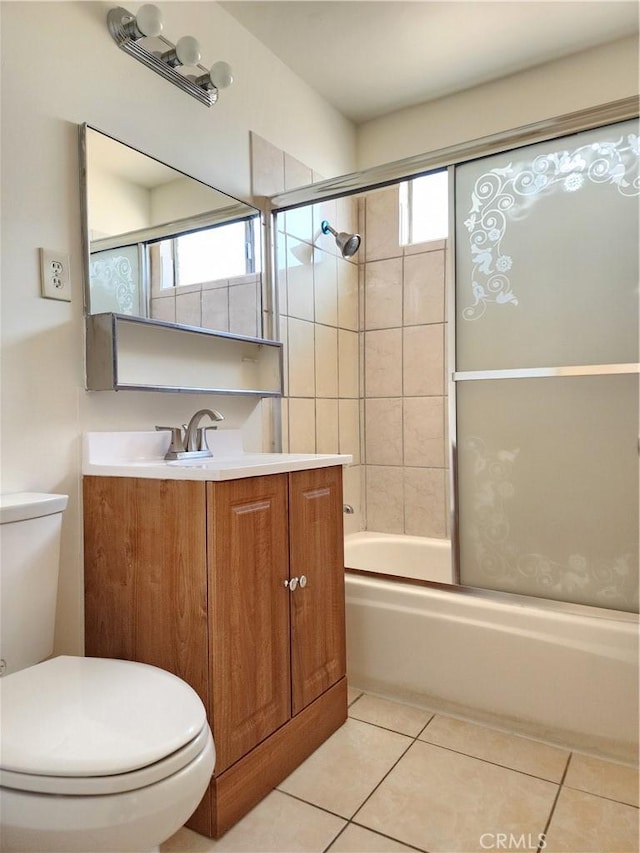 full bathroom with tile patterned floors, vanity, toilet, and bath / shower combo with glass door