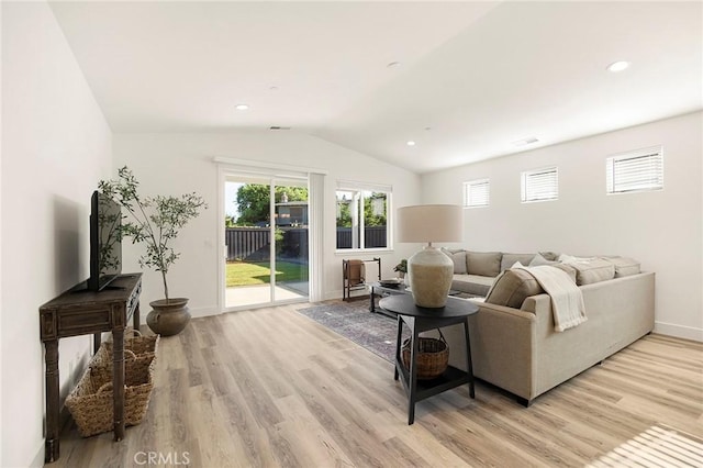 living room featuring light hardwood / wood-style flooring and lofted ceiling