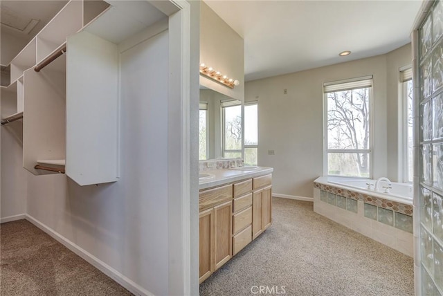 bathroom featuring vanity and a tub