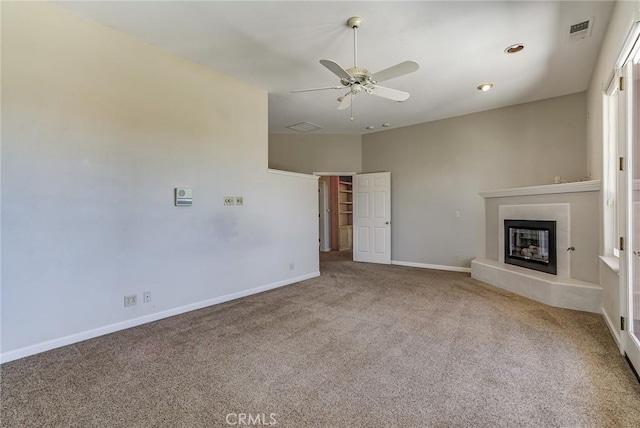 unfurnished living room featuring light carpet and ceiling fan