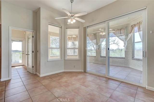 interior space with light tile patterned floors and ceiling fan