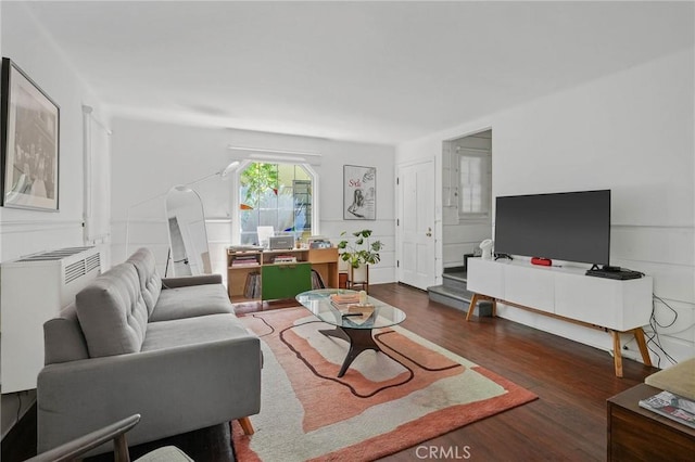 living room featuring dark hardwood / wood-style flooring and radiator