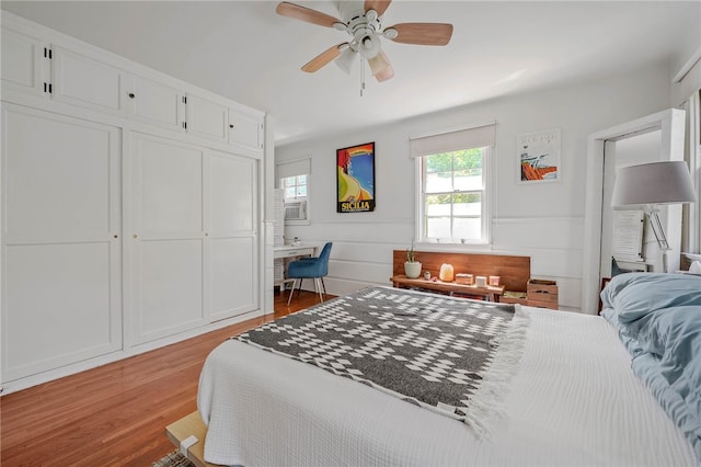 bedroom featuring ceiling fan, light hardwood / wood-style flooring, and a closet