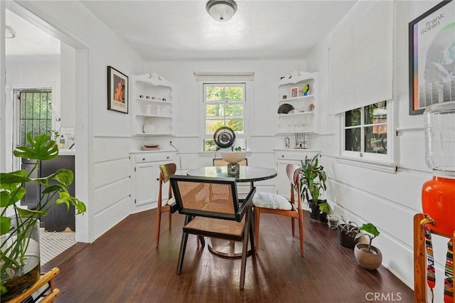 dining area with dark wood-type flooring and a wealth of natural light