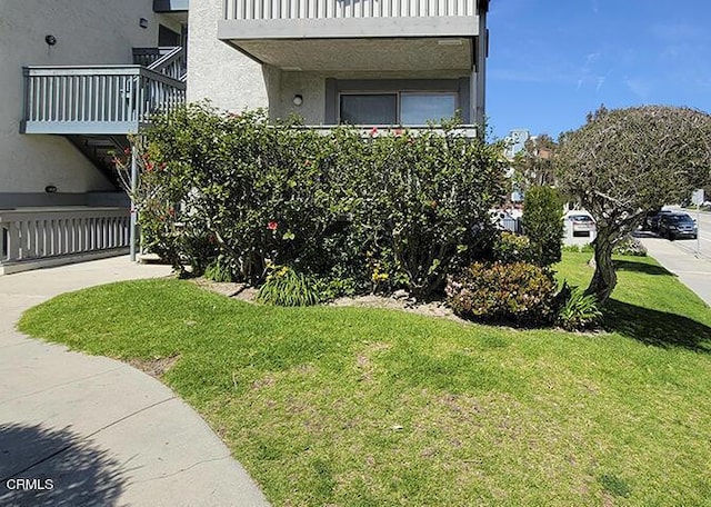 view of side of home featuring a yard