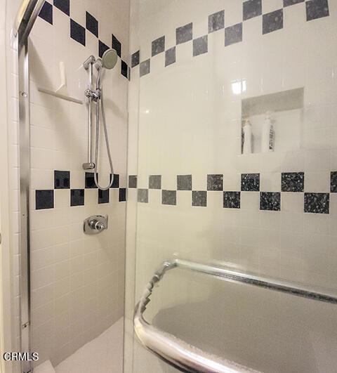 bathroom with a shower with shower door